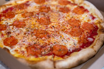 Large pizza cut into pieces, close-up. Selective focus