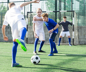 Two youth teams play football. Free kick on goal