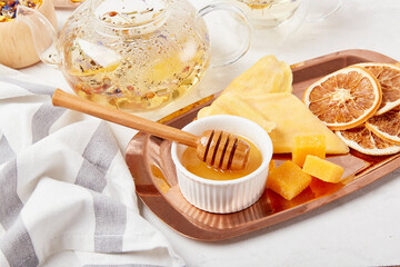 Aesthetic tea time, herbal tea table setting with natural honey close up. Natural organic tea - natural sustainable eco-friendly lifestyle. Soothing tea ceremony vibes.