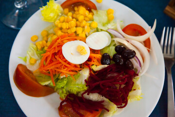 Mixed salad with eggs, fresh vegetables and boiled beet and carrot