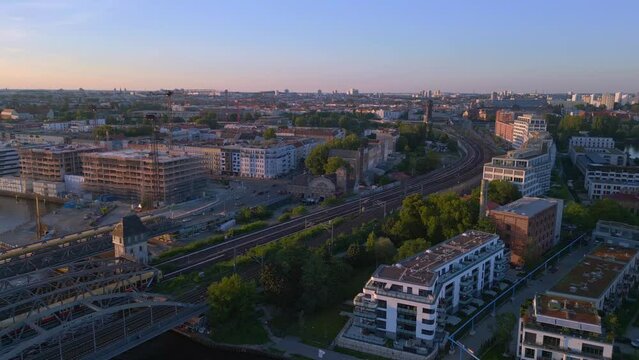 suburban train river bridge Berlin sunset. Marvelous aerial view flight drone