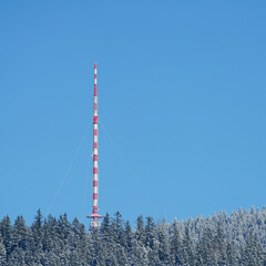 Radio antenna tower in winter on the mountains