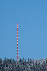 Radio antenna tower in winter on the mountains