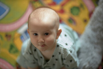 A baby is a happy baby in the first months of life, crawling around the house, smiling.