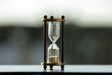 Old vintage hourglass with sand flowing down inside. Conceptual video of time and hours passing day...