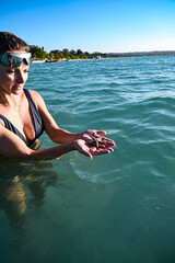 Woman holding starfish on the beach in Jamaica