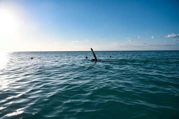 Woman swimming and exercising on the beach in Jamaica