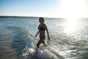 Woman swimming and exercising on the beach in Jamaica