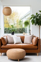 brown leather sofa in front of a large window with plants