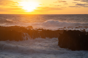 Sunset at Azores, waves crushing on the rocks