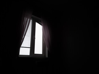 Window in dark room with free space on the right side.