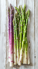 Fresh asparagus bunches, green purple white, healthy organic vegetable, rustic background.