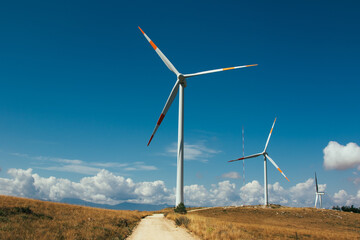 Slow motion fast video of  wind farm or wind park at sunset located in the mountains of Italy...