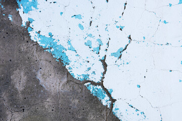 Abstract background of old shabby concrete wall surface with bright turquoise and white paint and...