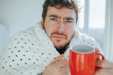 Winter Coziness Tousled Hair Man Covered in Duvet at Home