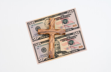 Banknotes with wooden cross