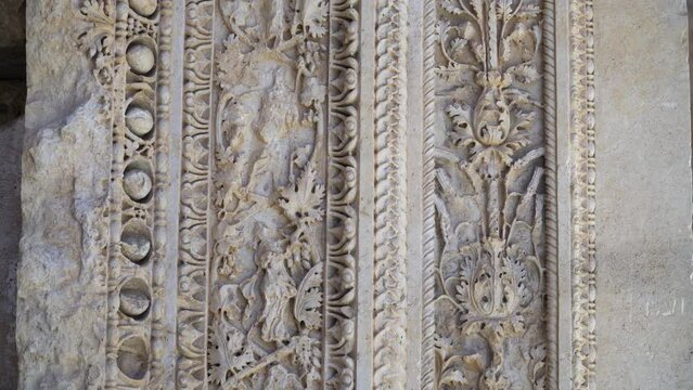 Stone carvings at the entrance to the ancient Roman Temple of Bacchus in Baalbek, Lebanon. Close-up capture.