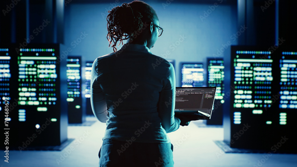 Poster dilligent worker running code on laptop, troubleshooting and upgrading high tech workplace infrastru