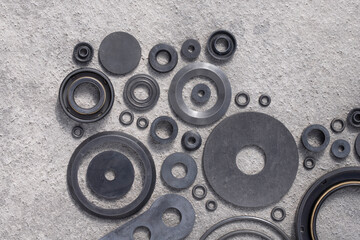 Rubber sealing technical gaskets for large vehicles on a gray structural surface with space for...