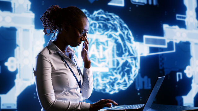 African american engineer develops artificial intelligence neural networks architecture inspired by human brain. Woman with IT expertise setting up AI machine learning algorithms in high tech startup