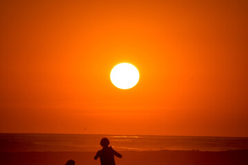 Embark on a journey of serenity with this captivating sunset photograph taken on a pristine Costa Rican beach. The awe-inspiring beauty of the sun setting over the horizon transforms the sky into a vi