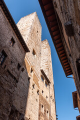 Fototapeta premium In the streets of San Gimignano, view on the towers Salvucci