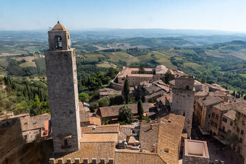 Wide panoramic view over downtown San Gimignano, seen from Torre Grosso - obrazy, fototapety, plakaty