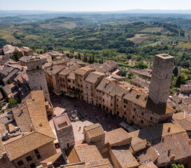 Wide panoramic view over downtown San Gimignano with Torre del Diavolo and Torre dei Becci, seen...