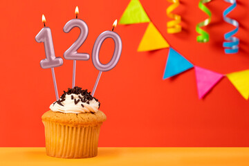 Number 120 Candle - Birthday cake on orange background with bunting
