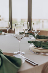 Fototapeta premium Crystal glasses for spirits: wine, whiskey, cognac, vodka. Table setting in a restaurant. Holiday. Wedding. Birthday.