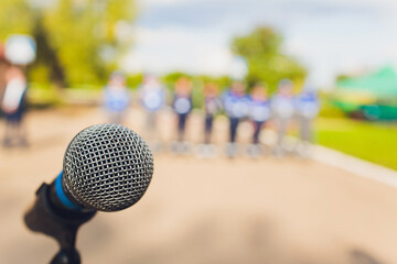 closeup microphone in blurred background with effect film bright light filter, single microphone in...