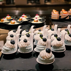 Cupcakes and meringues on display in a pastry shop