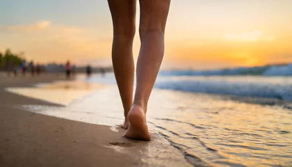 Foto op Plexiglas Closeup of woman's feet on sandy beach at sunset, evoking travel, relaxation, and summer vibes © Your Hand Please