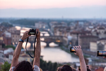 Large tourist crowd on Piazzale Michelangelo enjoying sunset over Florence - obrazy, fototapety, plakaty