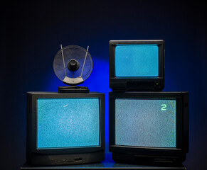 old TVs on a dark background