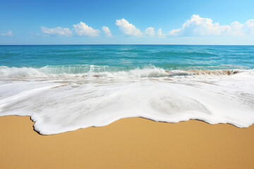 A foamy wave crashing onto a sandy beach, turquoise, blue sky
