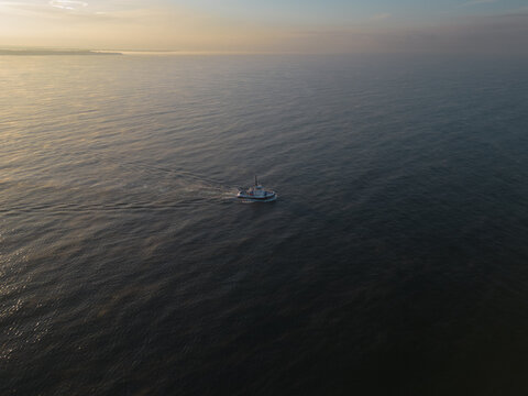 A tug sails on the sea in the Paldiski area at sunset.