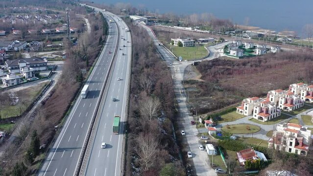 Colorful residences overlooking Sapanca Lake, with views of the Anadolu Highway on a cold winter day. Experience the magic of Turkey from a bird's-eye view
