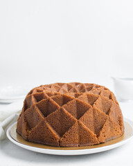 Vanilla bundt cake on a white tray, homemade bundt cake on a white background