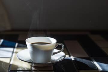 Cup of hot coffee on a table,