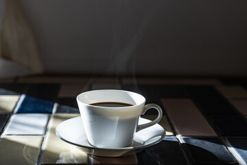 Cup of hot coffee on a table,