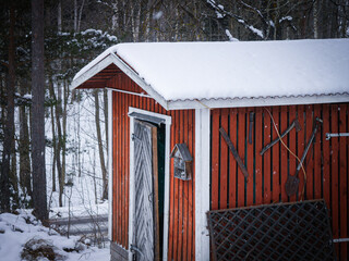 a red tool shed during the winter