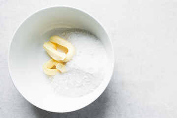 Butter and sugar in a white mixing bowl, the process of making a cake, mixing butter and sugar to make a cake	