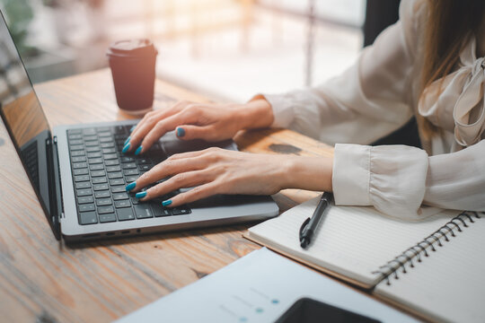 Young female entrepreneur freelancer working using a laptop in coworking space.