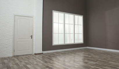 Empty room with brown walls and large window
