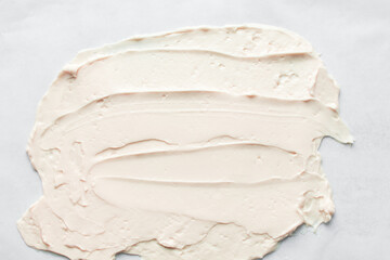 Top view of pink buttercream for decorating cake, silky smooth american buttercream on a marble surface, overhead view of smooth buttercream