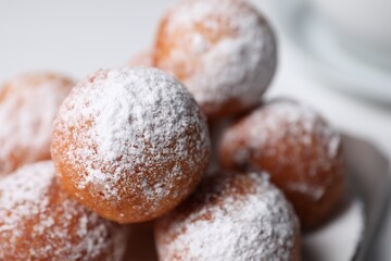 Fototapeta na wymiar Delicious sweet buns with powdered sugar on white table, closeup