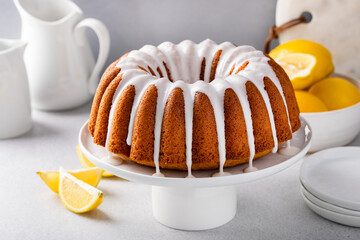 Lemon bundt cake on a cake stand with powdered sugar glaze