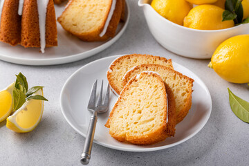 Lemon bundt cake sliced on a plate with powdered sugar glaze