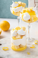Lemon trifle with pound cake, lemon curd and meringue in coupe glasses - obrazy, fototapety, plakaty